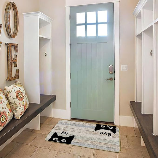 Grey indoor/outdoor doormat with black cat faces and “Hi” and “Bye” lettering