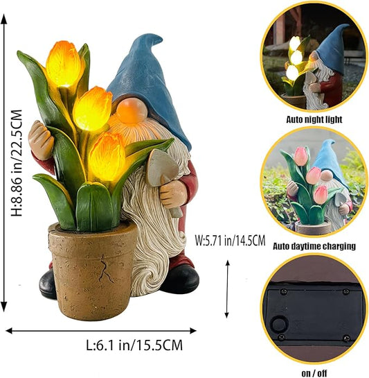 Solar garden gnome statue holding yellow tulips in a brown pot, blue hat, front view.