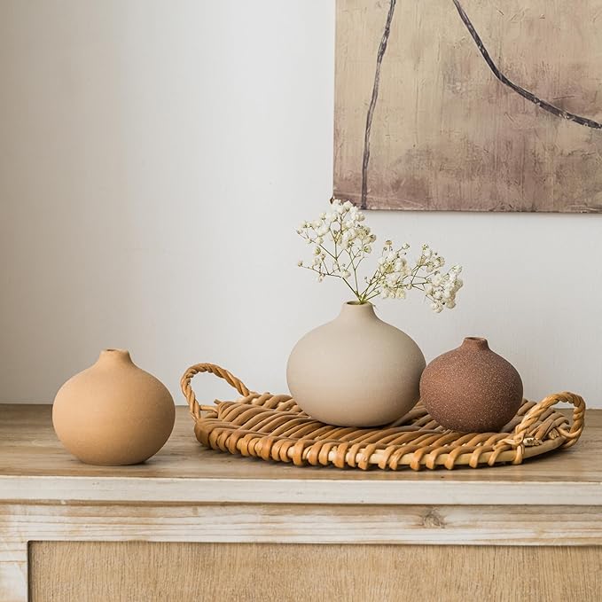Set of 3 matte ceramic bud vases on a woven tray, one holding small flowers