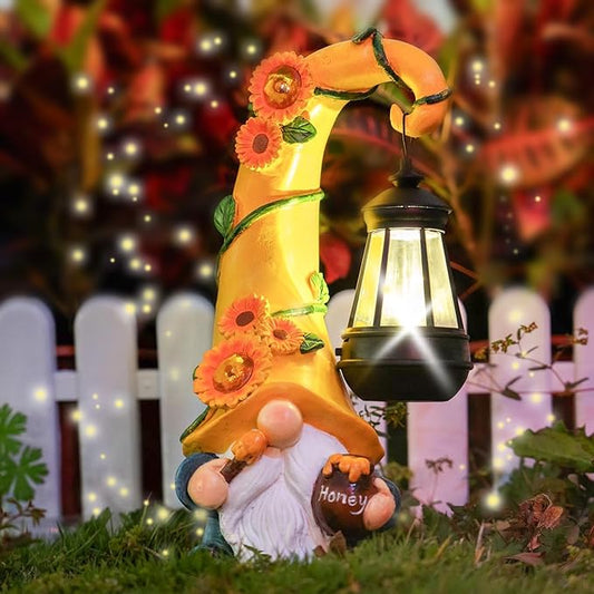 Yellow fall gnome figurine with sunflower garland, holding a black solar lantern