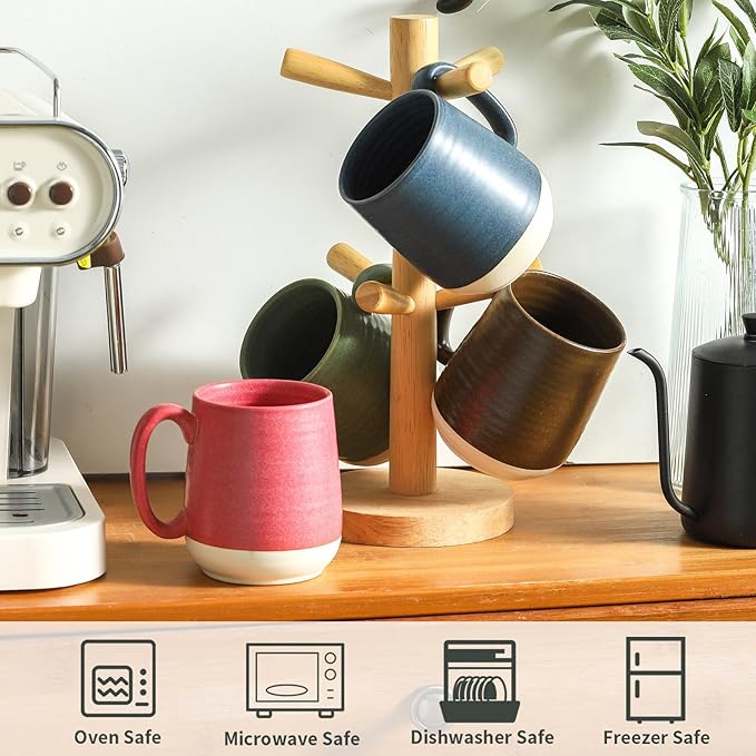 Ceramic coffee mugs on a wooden rack: red, brown, and blue mugs with handles.