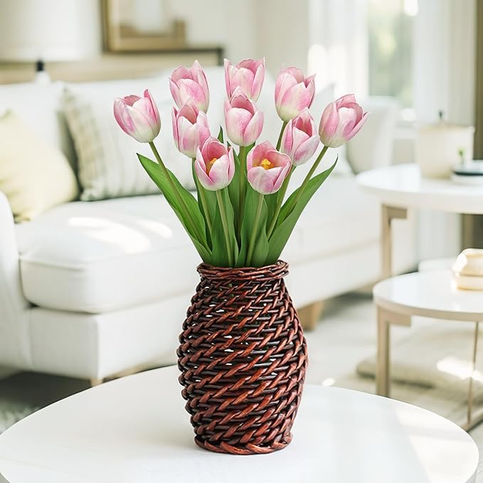Pink faux tulip stems in a brown woven vase