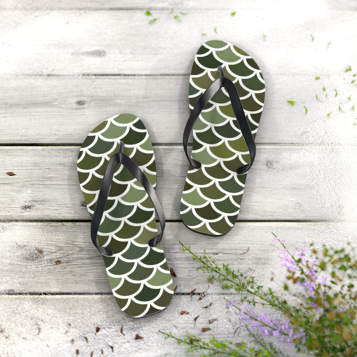 Two green scale print flip flops with black straps