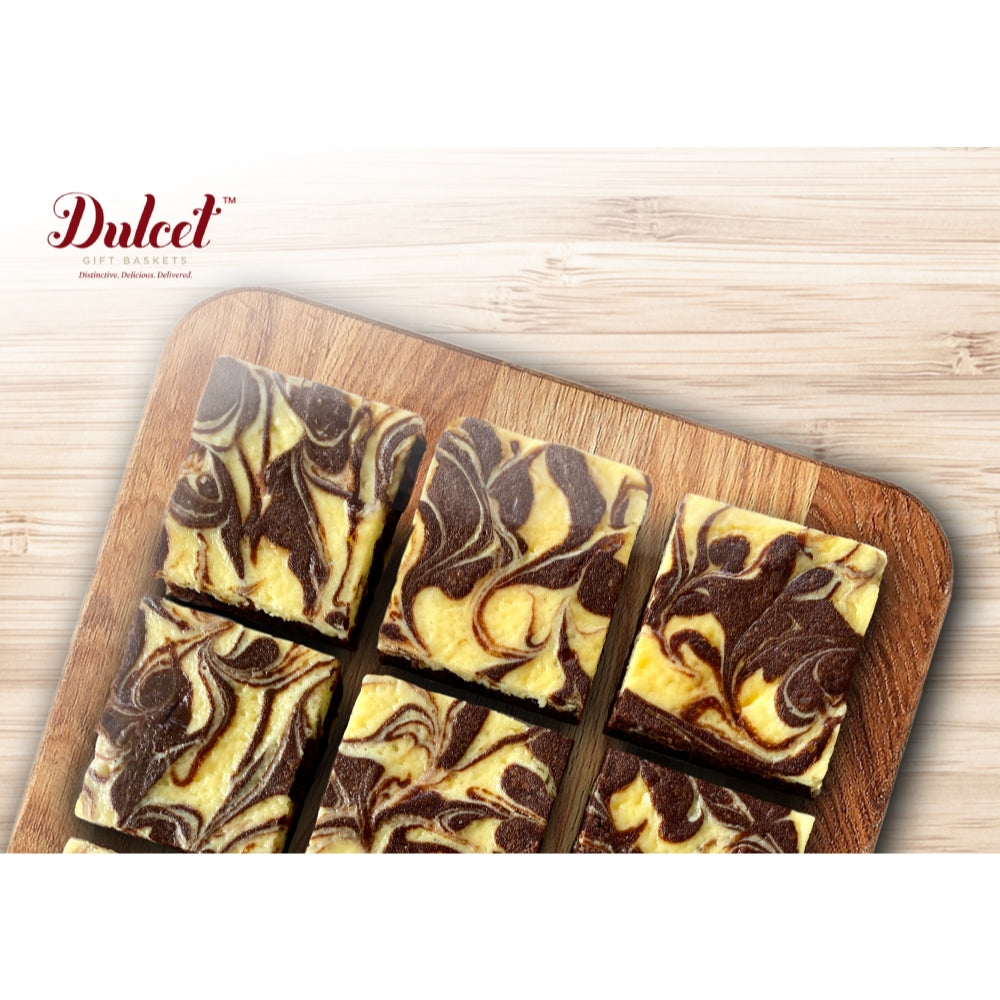 Swirled chocolate and vanilla brownies in a wooden tray, cut into squares