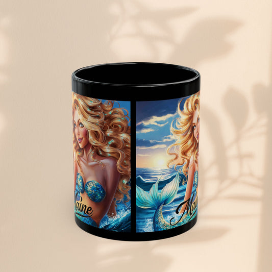 Black ceramic mug with mermaid-themed wrap artwork, partial 'Maine' text