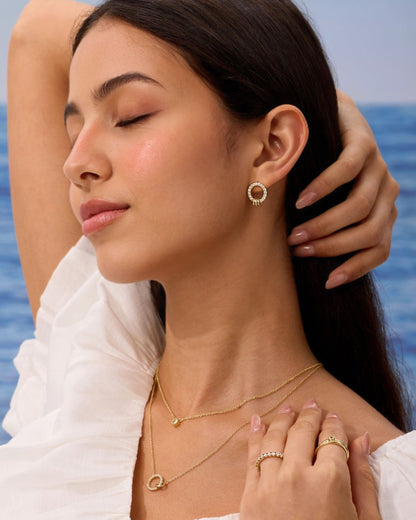 Gold pavé circle stud earrings worn on model
