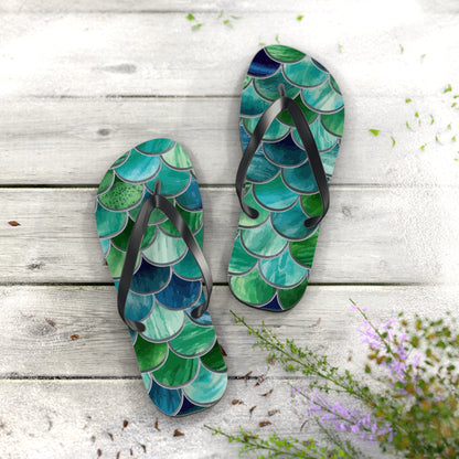 Mermaid-scale flip-flops pair with black straps and green-blue scale pattern on footbeds