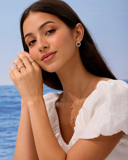 Gold pave circle stud earrings on model