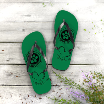 Green flip-flops standing pair with black straps and paw illustration on footbeds