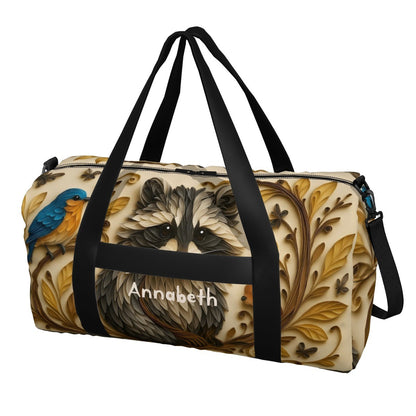 Front view duffel bag with raccoon print, blue bird accents, and black carry straps