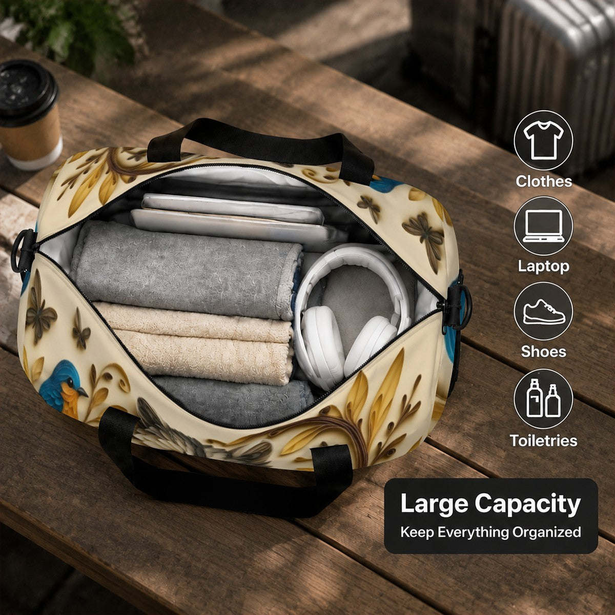 Open duffel bag with raccoon print showing folded clothes and headphones inside