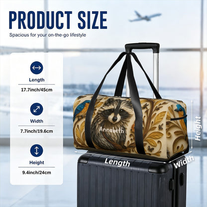 Raccoon print travel duffel bag with black straps placed on a rolling suitcase