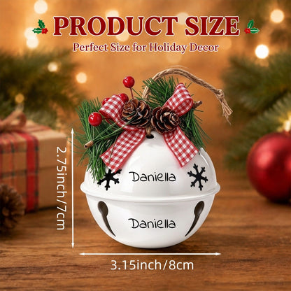 White holiday jingle bell ornament with pine, red plaid bow, berries, and snowflake cutouts