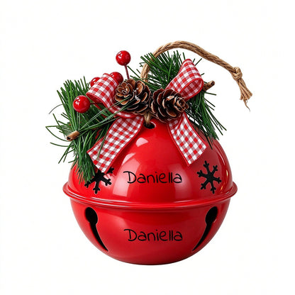 Red holiday jingle bell ornament with red plaid bow, pine, pinecones, and Daniella text