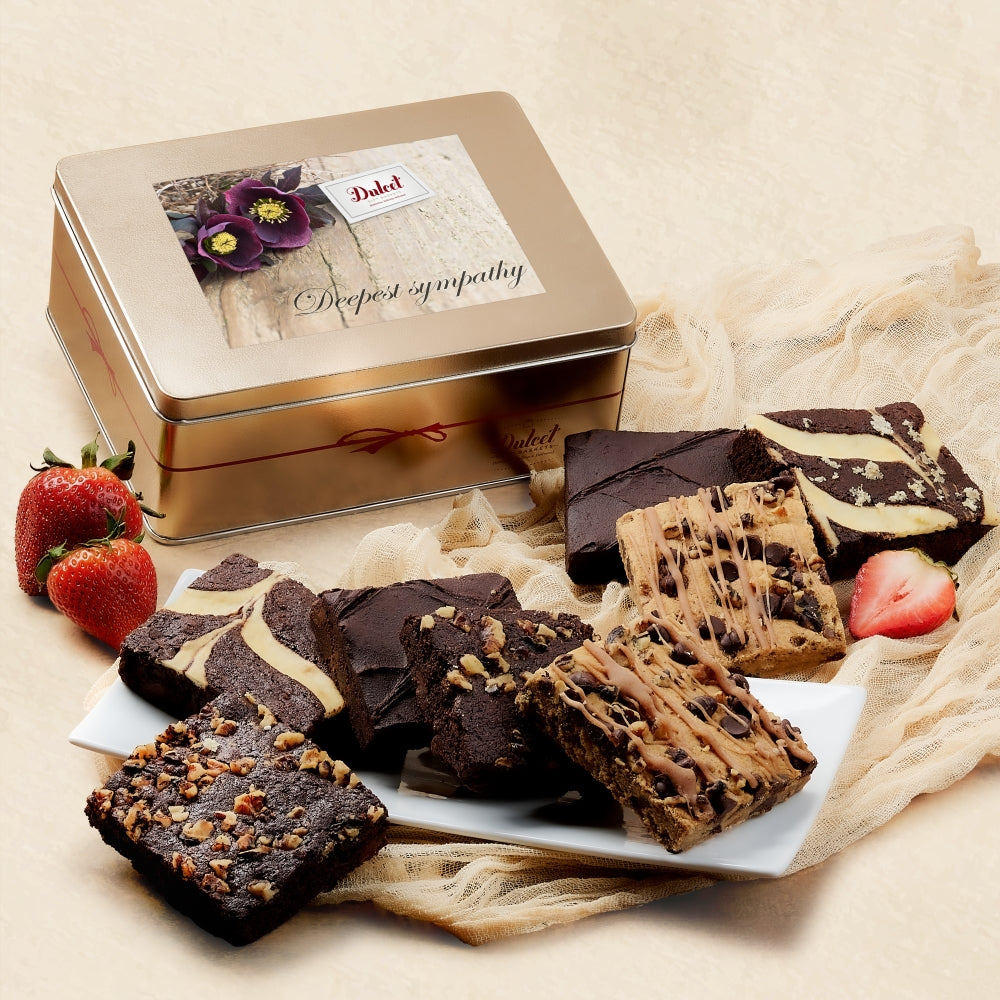 Gold gift tin with assorted chocolate and nut brownies, shown with strawberries