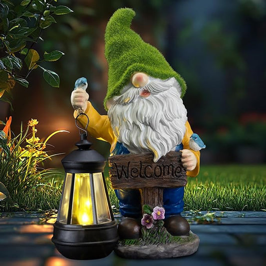 Outdoor solar gnome statue with green hat, white beard, blue pants, holding a glowing lantern