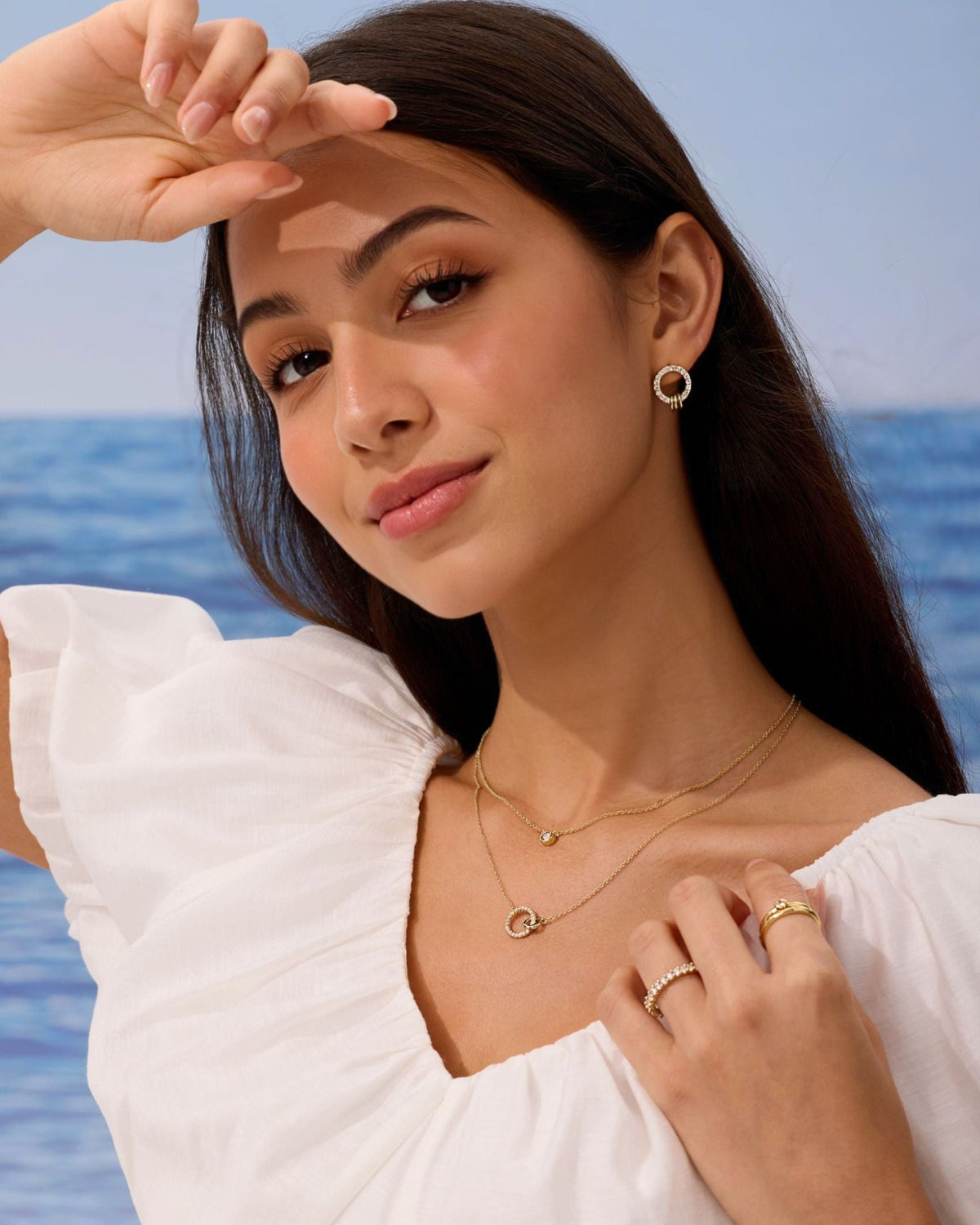 Pave circle stud earrings in gold, worn on a model