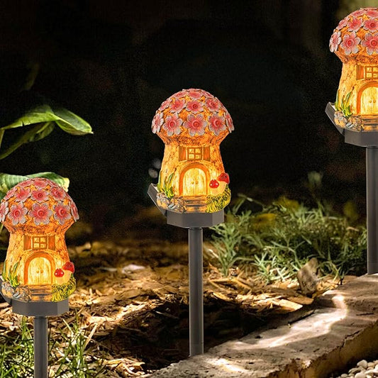 Glowing solar mushroom house outdoor light on tall black stake