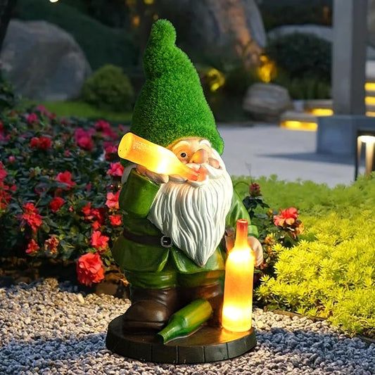 Resin garden gnome figurine with green cone hat, white beard, holding a glowing lantern