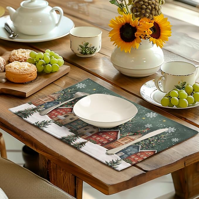 Green Christmas placemat on wooden table with dinner plate and teacups