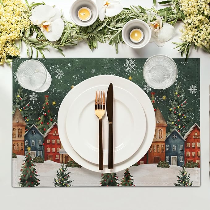 Green Christmas placemat with snowy town village, fir trees, and plate centered