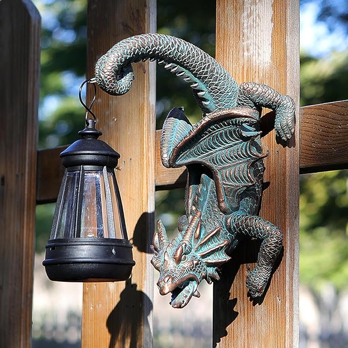 Solar dragon tree hugger statue with black lantern attached to a wooden post, detailed wings
