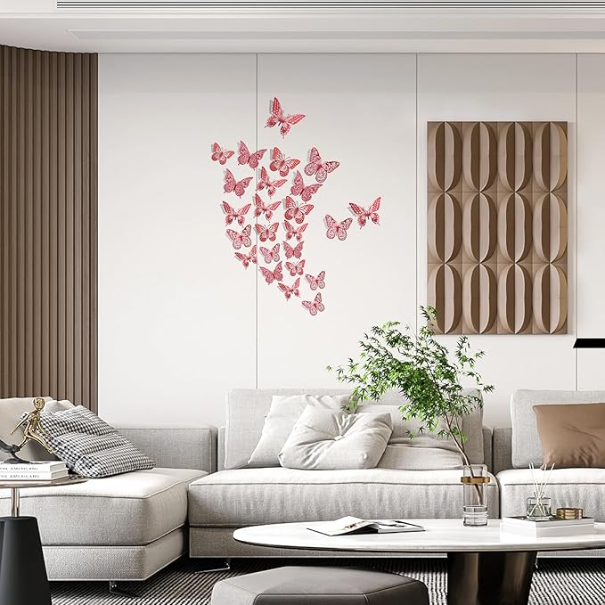 Red 3D butterfly wall decals arranged on a wall above a sofa