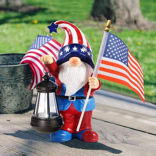 Patriotic solar gnome statue with American flag, lantern, and striped pennant