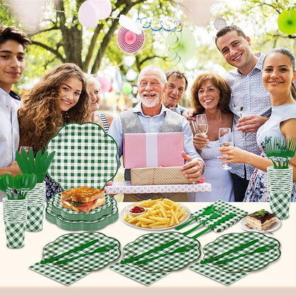 Green-and-white gingham picnic tableware set on a table with plates, cups, and utensils