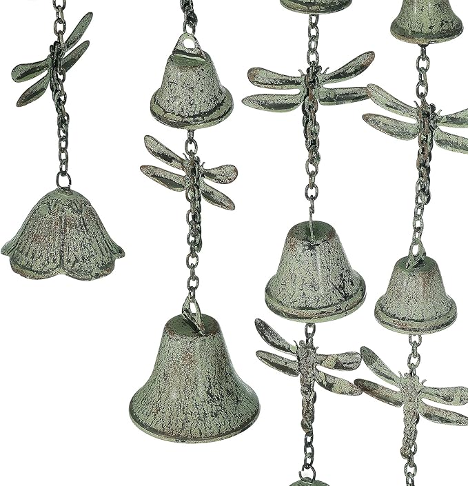 Close-up of verdigris metal wind chime bells with dragonfly-shaped ornaments