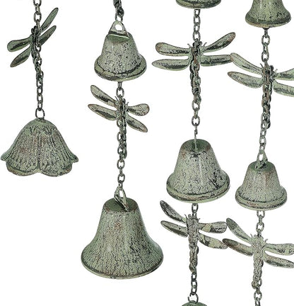 Close-up of verdigris metal wind chime bells with dragonfly-shaped ornaments
