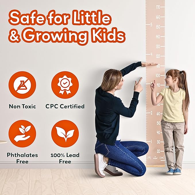 Kids using height growth wall chart with a wall ruler scale for measuring