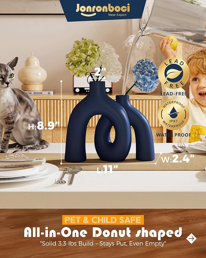 Matte navy ceramic hug sculpture vase with two conjoined rounded openings.