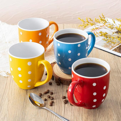 Ceramic coffee mugs with white polka dots in orange, yellow, blue, red, and navy on wood.