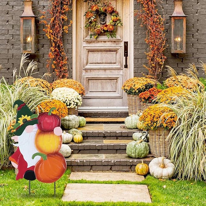 Outdoor garden stake gnome decoration among fall pumpkins and flowers, multicolor orange and red