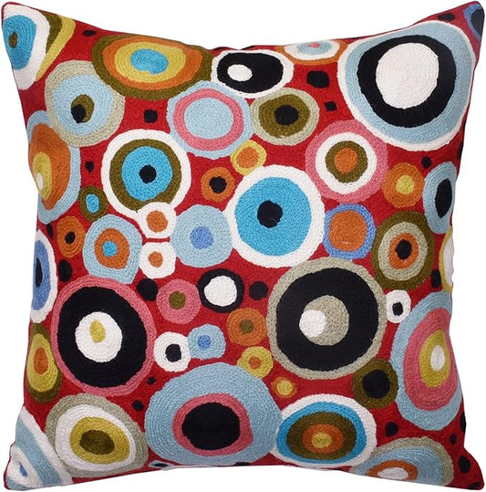 Red decorative pillow cover with colorful circular embroidered pattern, textured front