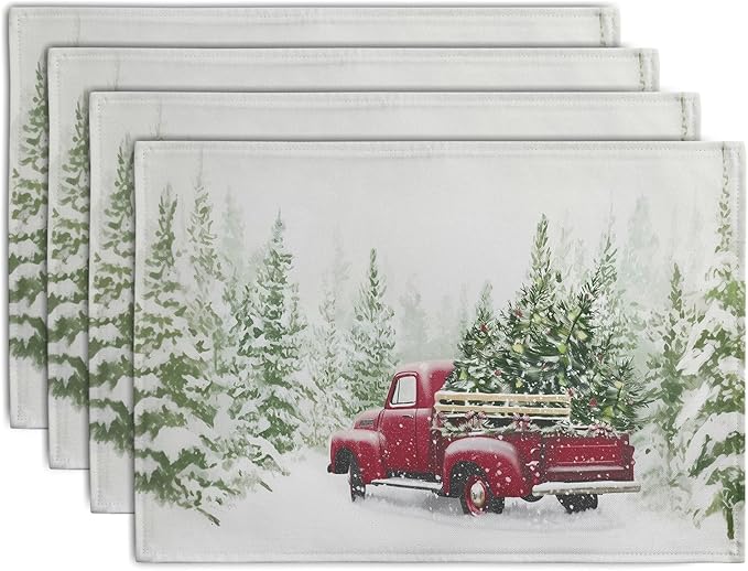 Set of four Christmas placemats with red truck and pine tree in snowy scene