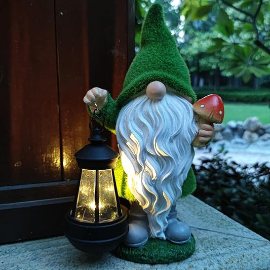 Solar garden gnome statue with green hat, white beard, holding a mushroom and glowing lantern