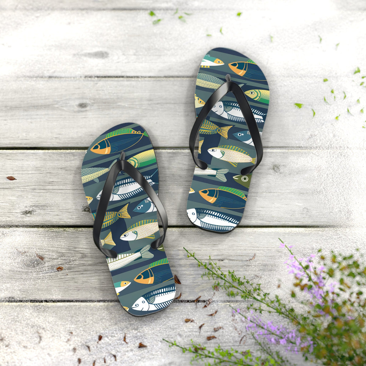 Pair of fish-print flip flops with black straps and dark blue patterned footbeds
