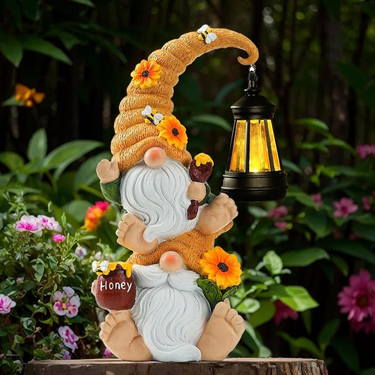Garden gnome solar light statue with lantern, orange hat, white beard, holding a honey jar