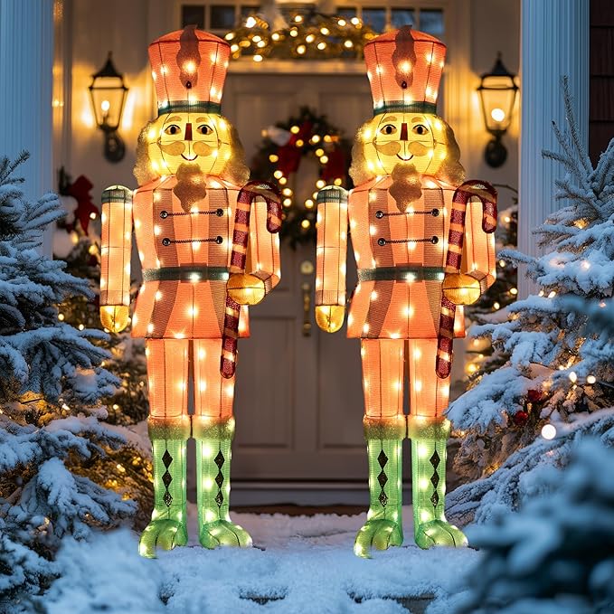 Pair of LED-lit nutcracker yard stakes in red-and-white coats with glowing green boots