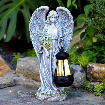 Gray angel garden statue holding a lantern, detailed resin wings and floral accents.