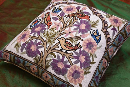 Side view of embroidered floral bird pillow cover with tree motif and purple flowers