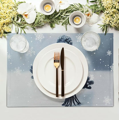Blue snowman placemat with snowflake pattern, centered under white plate and cutlery