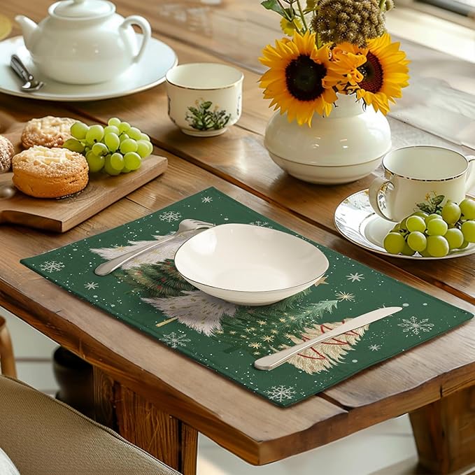 Green Christmas placemat with pine tree and snowflake design on dining table