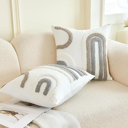 Tufted white pillow cover with gray arched motifs, sofa styling