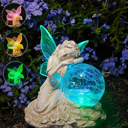 Winged fairy garden solar statue kneeling beside a glowing blue glass ball