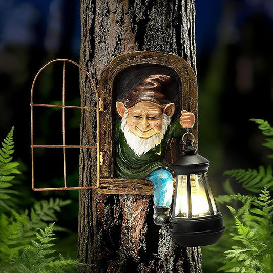 Outdoor resin garden gnome statue holding a solar lantern on a tree trunk