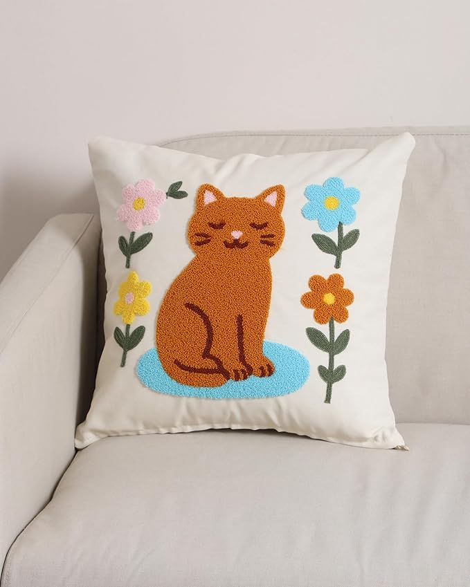 Cream pillow cover with stitched orange cat and colorful flower embroidery