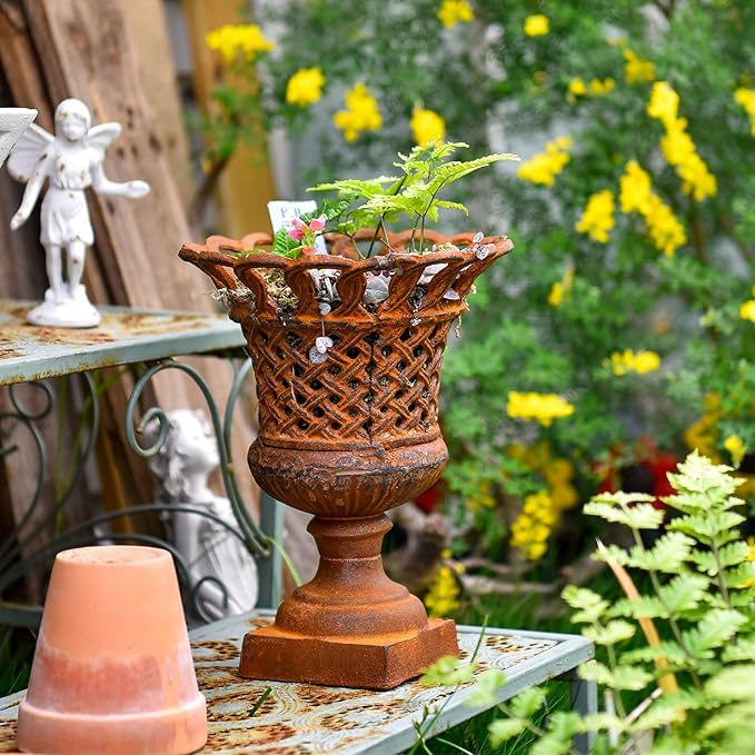 Cast-iron urn planter with open lattice pattern, flared rim, and dark bronze pedestal